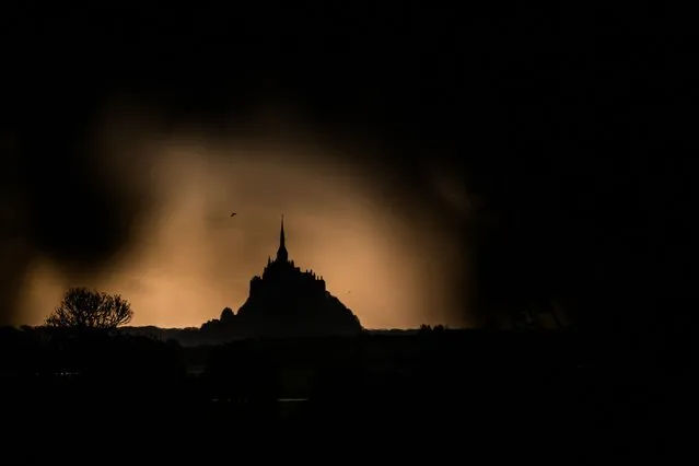 This photograph taken on October 30, 2023 from Avranche, shows the Mont-saint-Michel, western France. (Photo by Loic Venance/AFP Photo)