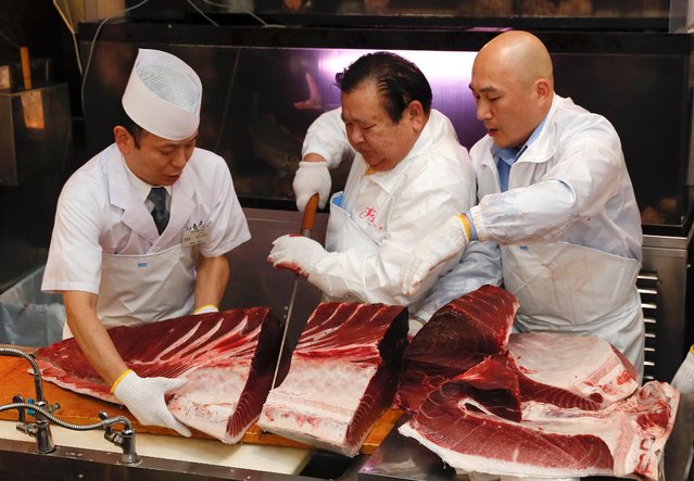 President Kiyoshi Kimora and staff of Japanese sushi chain Sushi-Zanmai cut a piece of the 278 kilogram Bluefin tuna fish during the New Year 2019 first auction of the Toyosu Market at his head restaurant at Tsukiji in Tokyo, Japan, 05 January 2019. (Photo by Kimimasa Mayama/EPA/EFE)
