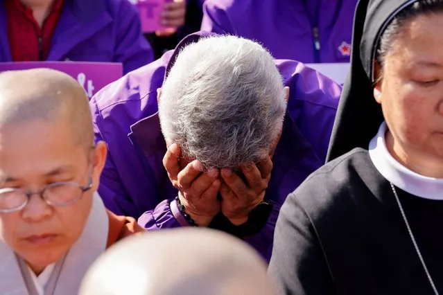 A family member of a victim who died from the Halloween crowd crush a year ago, mourns at a rally to commemorate one year anniversary of the deadly Halloween crowd crush in Seoul, South Korea on October 29, 2023. (Photo by Kim Soo-hyeon/Reuters)