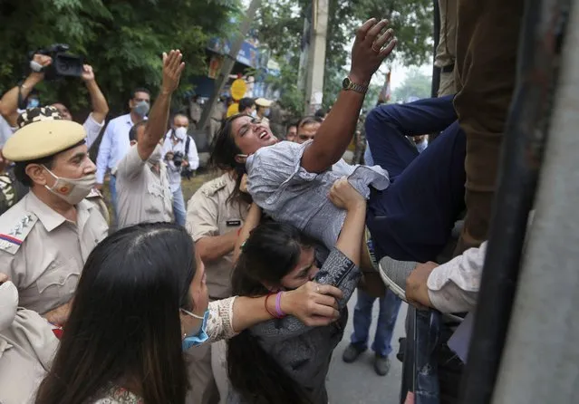Delhi Policewomen detain a youth congress party activist during a protest outside Twitter's office in New Delhi, India, Monday, August 9, 2021. The protest was against Twitter temporarily locking Congress party leader Rahul Gandhi's account after he tweeted a photograph of him meeting the family of a Dalit girl who was allegedly raped before being killed. (Photo by Manish Swarup/AP Photo)