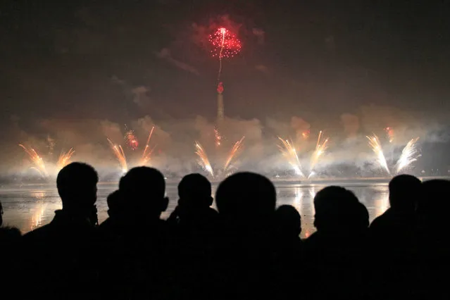 North Koreans gather to watch a New Year's fireworks display at the Kim Il Sung Square in Pyongyang, North Korea, on Sunday, January 1, 2017. (Photo by Kim Kwang Hyon/AP Photo)