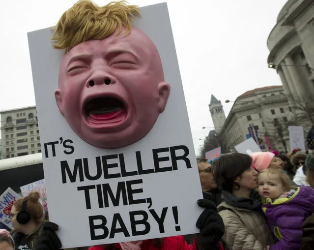 A group hold up signs at freedom plaza during the women's march in Washington on Saturday, January 19, 2019. (Photo by Jose Luis Magana/AP Photo)