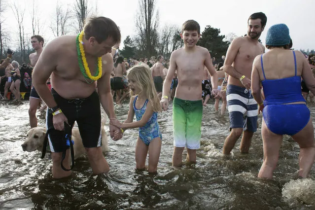 A girl pleads to go back to shore after entering Lake Washington during the 12th annual Polar Bear Plunge in Seattle, Washington January 1, 2014. (Photo by David Ryder/Reuters)