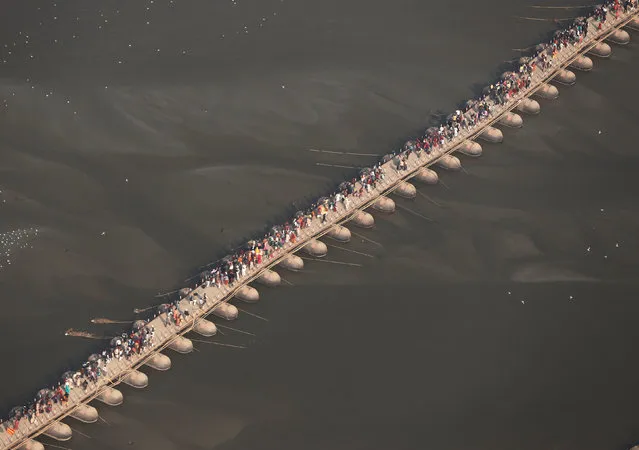 Devotees cross a pontoon bridge over the river Ganga during “Kumbh Mela”, or the Pitcher Festival, in Prayagraj, previously known as Allahabad, India, February 3, 2019. (Photo by Adnan Abidi/Reuters)