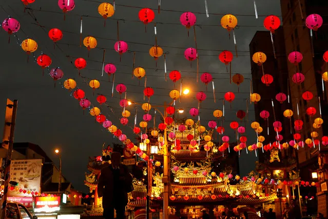 A tourist walks under the lanterns along a street ahead of the Chinese Lunar New Year outside Raohe street Night Market in Taipei, Taiwan January 18, 2017. (Photo by Tyrone Siu/Reuters)