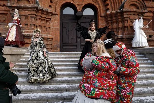 Women wearing costumes pose for pictures during photo shooting sessions, in front of the Saint Sophia Cathedral in Harbin, Heilongjiang province, China on January 5, 2024. (Photo by Tingshu Wang/Reuters)