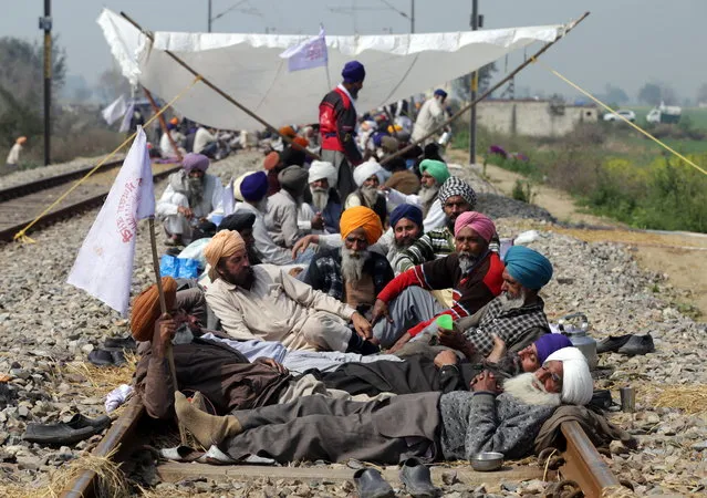 Farmers sit and rest on railway tracks during a protest organized under the banner of Kisan Mazdoor Sangharsh Committee (KMSC) against the alleged anti-farmer policies of the government, at village Devi Dass Pura, 20 kilometers from Amritsar, India, 05 March 2019. According to reports, protesting farmers are claiming the government policies are against their interests, and calling for better milk procurement rate, senior citizens' pension and debt waiver besides other demands. Due to the protest, 22 trains were cancelled and 24 diverted on the railway route between Amritsar and New Delhi. (Photo by Raminder Pal Singh/EPA/EFE)