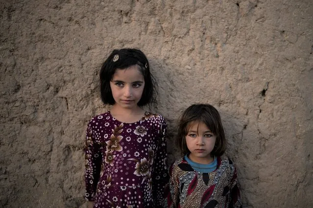 Zahra, 6, and Adina, 5, pose for a photo outside their home at a village in Wardak province, Afghanistan, Monday, October 11, 2021. (Photo by Felipe Dana/AP Photo)
