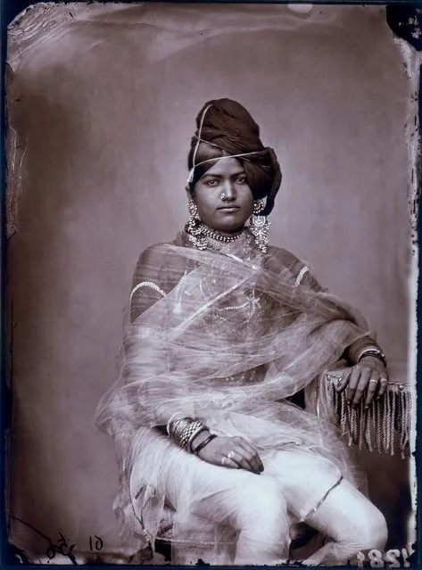 These images give a rare insight into the life of a 19th Century Indian Maharajah. Maharajah Ram Singh ruled in the famous pink city of Jaipur between 1835 and 1880, and was also a keen photographer. Despite being a child when he ascended to the throne, the Maharajah embraced modern amenities and under his leadership the city became one of the most distinctive in the country. He would often roam the streets incognito to observe how state officials were carrying out their work, and was recognised by the British Government, which added four guns to his salute and nominated him as a member of the Viceroy’s Legislative Council. During his reign new water works, gas works, museums and schools were built, and he devoted a lot of his time to capturing the costumes and culture of his people with his then state-of-the-art camera equipment. Here: Portrait of a woman in the harem of the royal palace of Jaipur, India, circa 1857. (Photo by Maharaja Ram Singh III/Alinari Archives, Florence/Alinari via Getty Images)