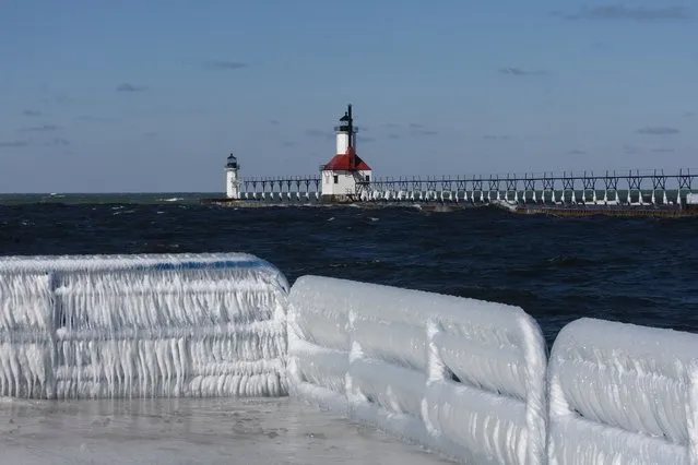 Ice builds up along a pier on Lake Michigan on February 18, 2024 in St. Joseph, Michigan. The Great Lakes shorelines have historically been ice-covered this time of year, but this winter's warm weather has led to the lowest ice cover over the lakes system since record keeping began in 1973. The loss of ice on the lakes is part of a decades-long trend which has seen the coverage drop by about 5% a year since the 1970s. (Photo by Scott Olson/Getty Images)