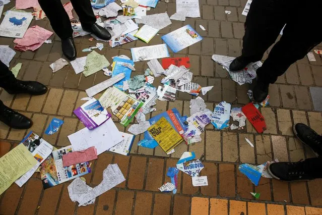Company brochures litter the floor at a job fair for college graduates and the general public in the centre of Shijiazhuang, Hebei province, China, February 6, 2017. (Photo by Thomas Peter/Reuters)