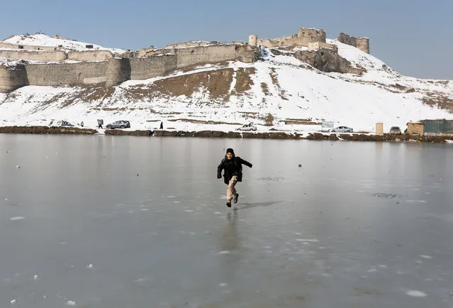 An Afghan boy plays on a frozen lake in Kabul, Afghanistan February 8, 2017. (Photo by Mohammad Ismail/Reuters)