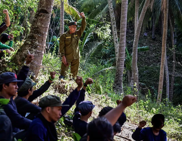 Jaime “Ka Diego” Padilla (top-C), spokesperson of the Melito Glor Command of the New People's Army (NPA) raises his fist along side his comrades during their 50th founding anniversary celebration at an undisclosed location in the mountains of Sierra Madre, Philippines, 31 March 2019. The Philippines’ defence department has said that “for five long decades, the NPA stained our soil with blood, extorted from our hardworking people, harassed our communities, and tore Filipino families apart”. It has vowed the insurgents will become strategically irrelevant by 2022, the year Duterte’s six-year term ends. (Photo by Alecs Ongcal/EPA/EFE)