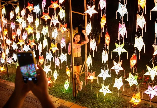 People take photos during the Loy Krathong festival which is held as a symbolic apology to the goddess of the river in Chiang Mai, Thailand, November 19, 2021. (Photo by Soe Zeya Tun/Reuters)