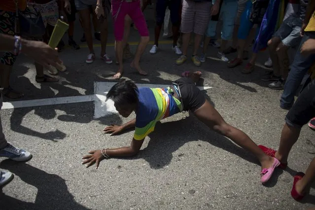 A transgender performs during the Eighth Annual March against Homophobia and Transphobia in Havana, May 9, 2015. More than 1,000 gay, lesbian and transgender Cubans marched through Havana on Saturday, proudly displaying their truest selves for a day in a society where they still endure discrimination. (Photo by Alexandre Meneghini/Reuters)