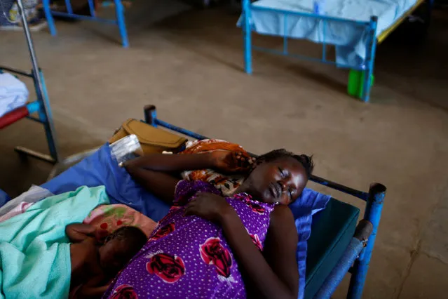 A mother with her child sleep in a bed of the paediatric ward of an hospital in the United Nations Mission in South Sudan (UNMISS) Protection of Civilian site (PoC), outside the capital Juba, South Sudan, January 24, 2017. (Photo by Siegfried Modola/Reuters)