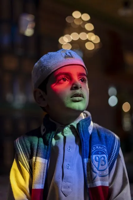 A Kashmiri Muslim boy poses for a picture inside a shrine as Muslims around the world observe the Islamic fasting month of Ramadan on March 14, 2024. (Photo by Abbas/SOPA Images/Rex Features/Shutterstock)