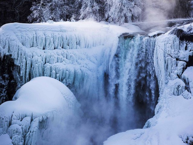 The atmosphere around Niagara Falls is indeed astonishing and quite eerie as the freezing temperatures create misty spectacle. (Photo by Mark Blinch/Reuters)