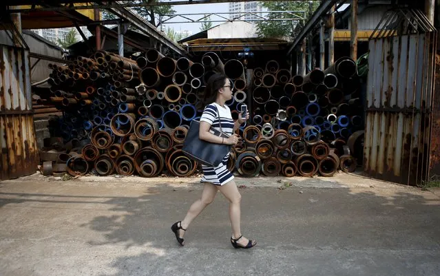 A woman runs past steel products stacked at a steelworks in Seoul, South Korea, in this July 15, 2015 file photo. (Photo by Kim Hong-Ji/Reuters)