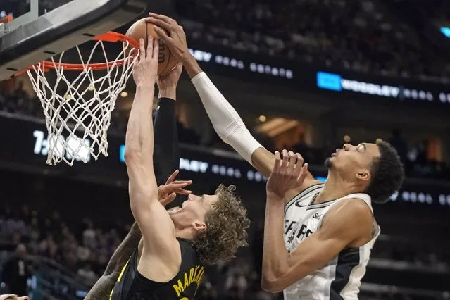 San Antonio Spurs center Victor Wembanyama, right, blocks Utah Jazz forward Lauri Markkanen, left, as he goes to the basket during the first half of an NBA basketball game Wednesday, March 27, 2024, in Salt Lake City. (Photo by Rick Bowmer/AP Photo)