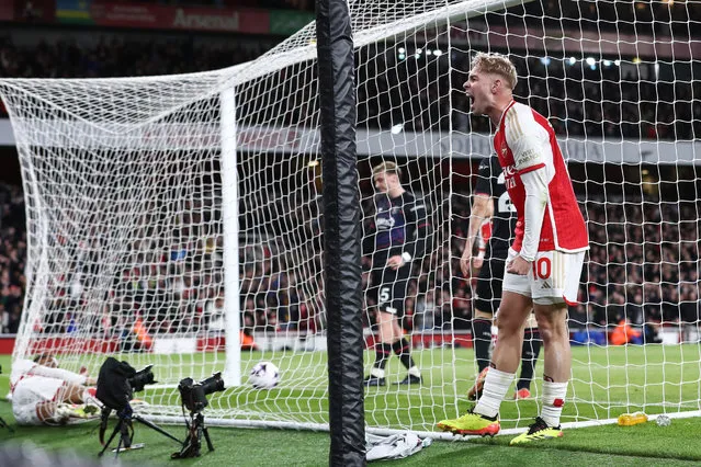 Emile Smith Rowe of Arsenal celebrates their second goal as scorer Reiss Nelson of Arsenal falls into the net during the Premier League match between Arsenal FC and Luton Town at Emirates Stadium on April 3, 2024 in London, England.(Photo by Jacques Feeney/Offside/Offside via Getty Images)