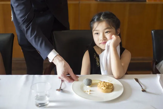 A girl takes part in an English manners and etiquette training course in Shanghai, China on April 7, 2016. The programme offers children of wealthy Chinese families the opportunity to learn about English style and etiquette. (Photo by Rex Features/Shutterstock)