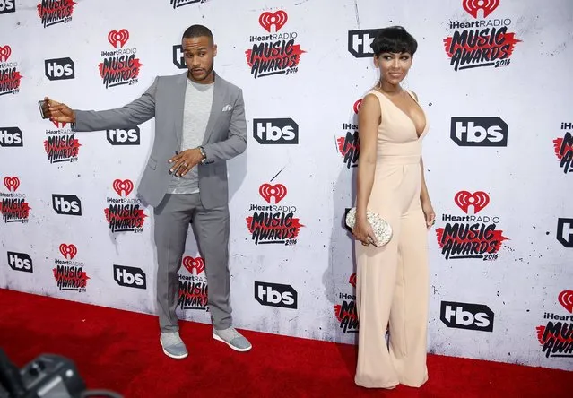 Actress Meagan Good (R) poses on the red carpet as her husband DeVon Franklin (L) takes a selfie photo with her at the 2016 iHeartRadio Music Awards in Inglewood, California, April 3, 2016. (Photo by Danny Moloshok/Reuters)