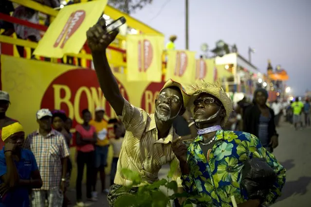 Two performers strike a pose for a selfie on the Carnival parade route in Les Cayes, Haiti, Monday, February 27, 2017. Haiti's Carnival is a mixture of Catholic pre-Lenten festivities and African, Spanish and native cultures found throughout the Americas and the Caribbean. (Photo by Dieu Nalio Chery/AP Photo)