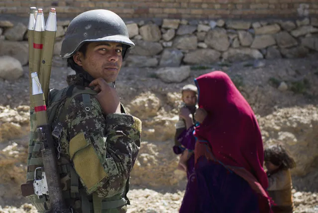 An Afghan National Army soldier carries his rockets while on patrol  in Logar province, east Afghanistan, Thursday, May 17, 2012. (Photo by Anja Niedringhaus/AP Photo)