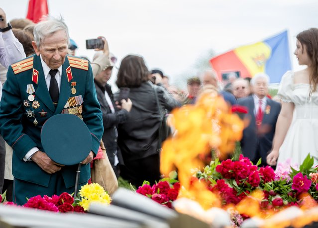 A veteran places flowers at the Eternal Flame in the Eternity Memorial Complex during the commemoration ceremony to mark the 79th Victory Day in Chisinau, Moldova, 09 May 2024. Former Soviet Republics celebrate the victory over Nazi Germany in World War II on 09 May. (Photo by Dumitru Doru/EPA/EFE)