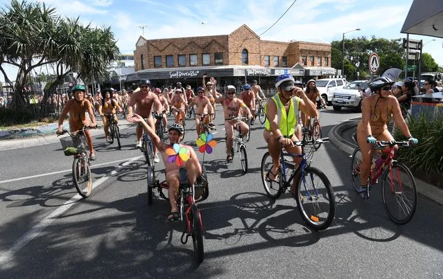 Naked protestors on bikes ride through the main streets on March 14, 2021 in Byron Bay, Australia. The ride aims to highlight the vulnerability of cyclists to motorists, promote cycling as an alternative to the modern car culture and to encourage positive body image to everyone. (Photo by James D. Morgan/Getty Images)
