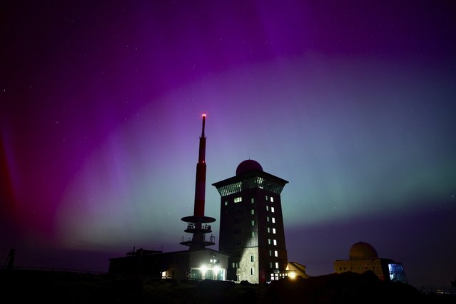 Northern lights appear in the night sky above the Brocken early Saturday, May 11, 2024, in Schierke, northern Germany. (Photo by Matthias Bein/dpa via AP Photo)