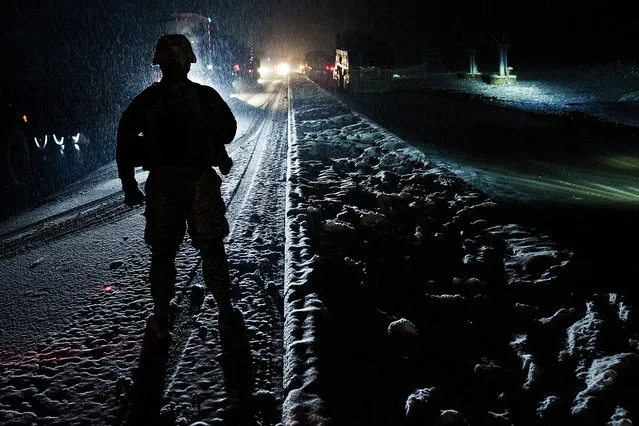 As the snow falls, U.S. Army Spc. David A. Brooks, a chemical, biological, radiological and nuclear specialist from Virginia Beach, Va., assigned to Forward Support Company G, 2nd Battalion, 320th Field Artillery Regiment, Task Force Balls, provides security during a recent convoy in eastern Afghanistan's Nangarhar Province, February 28. The convoy from Jalalabad to Bagram Airfield took more than 12 hours. (Photo by U.S. Army Sgt. 1st Class Mark Burrell/Task Force Bastogne)