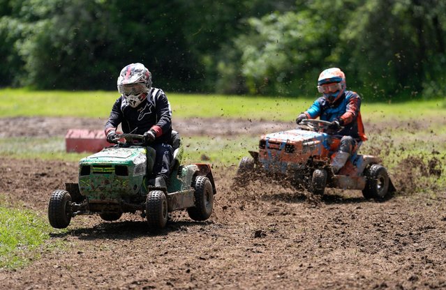 Competitors race in a heat during the World Lawnmower Championships, held by the British Lawn Mower Racing Association at Pondfield Farm, Alford, Surrey on Sunday, May 26, 2024. (Photo by Andrew Matthews/PA Images via Getty Images)