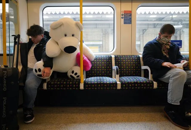 A person with a Valentine's Day gift on the Circle line, in east London on Monday, February 14, 2022. (Photo by Victoria Jones/PA Images via Getty Images)