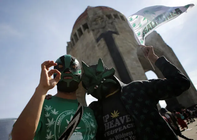 Demonstrators wearing masks gestures during a rally for the legalization of marijuana near at Mexico City's Monument to the Revolution, Mexico, May 7, 2016. (Photo by Henry Romero/Reuters)