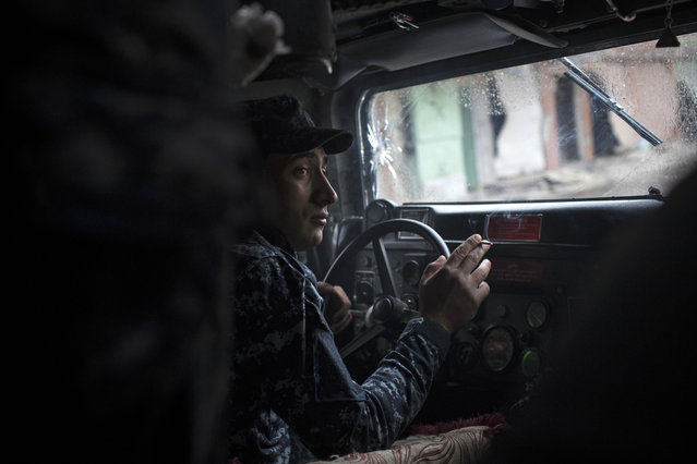 In this Monday, March 13, 2017 file photo, an Iraqi federal policeman drives a humvee during fighting against Islamic State militants in western Mosul, Iraq. (Photo by Felipe Dana/AP Photo)