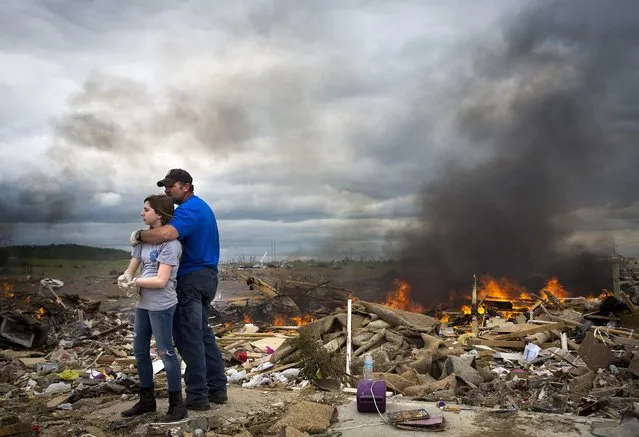 Michael Stanek hugs his daughter Kennedy Stanek as they take a break from helping friends sift though the rubble of their homes in Vilonia, Arkansas April 30, 2014. Severe floods in Florida's Panhandle and coastal Alabama deluged roads and engulfed homes and cars on Wednesday, the latest mayhem created by a tornado-packing storm system that has killed at least 34 people in the United States this week. (Photo by Carlo Allegri/Reuters)