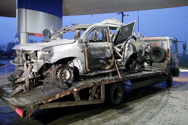 The damaged vehicle that drove over a mine while transporting members of the Organization for Security and Cooperation in Europe (OSCE), who were killed and injured from the incident on Sunday, is seen at a petrol station while it is moved from the scene in Luhansk region, Ukraine, April 23, 2017. (Photo by Alexander Ermochenko/Reuters)