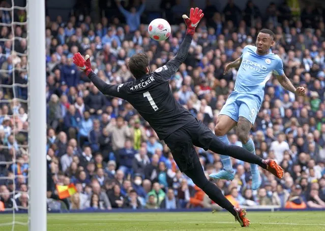 Manchester City's Gabriel Jesus, right, scores his side's second goal during the English Premier League soccer match between Manchester City and Liverpool, at the Etihad stadium in Manchester, England, Sunday, April 10, 2022. (Photo by Jon Super/AP Photo)