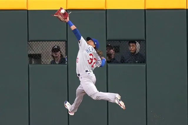 Chicago Cubs center fielder Michael Hermosillo (32) catches a fly ball hit by Atlanta Braves' Travis d'Arnaud (16) in the sixth inning of a baseball game, Tuesday, April 26, 2022, in Atlanta. (Photo by Brynn Anderson/AP Photo)