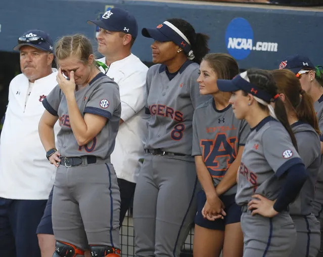 Auburn's Anna Gibbs, left, wipes her eyes as she and teammates watch Oklahoma celebrate after Oklahoma defeated Auburn 2-1 in the deciding game of the championship series of the NCAA softball College World Series, Wednesday, June 8, 2016, in Oklahoma City. (Photo by Sue Ogrocki/AP Photo)