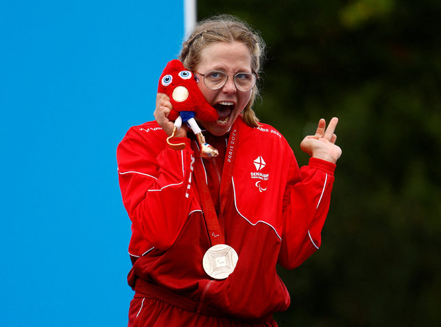 Bronze medallist Emma Lund of Denmark celebrates on the podium after the women's T1-2 individual road cycling time trial in Clichy-sous-Bois, France on September 4, 2024. (Photo by Maria Abranches/Reuters)