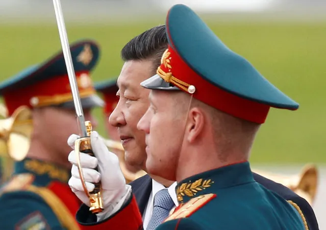 Chinese President Xi Jinping, surrounded by Russian honour guards, takes part in a welcoming ceremony upon his arrival at Moscow's Vnukovo airport, Russia July 3, 2017. (Photo by Sergei Karpukhin/Reuters)
