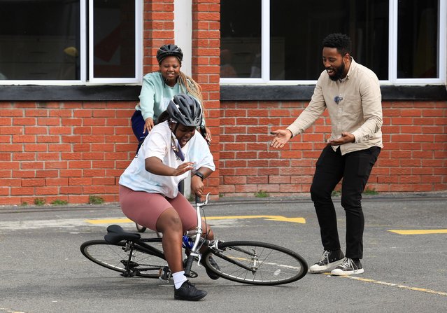 Sindile Mavundla known as Cape Town's “Bicycle Mayor” reacts to a rider during her first lesson in Pinelands where he is leading an initiative to promote the culture of cycling in Cape Town, South Africa, on September 13, 2024. (Photo by Esa Alexander/Reuters)