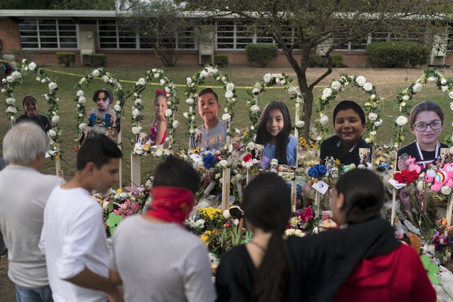 People gather at a memorial at Robb Elementary School in Uvalde, Texas Monday, May 30, 2022, to pay their respects to the victims killed in last week's school shooting. (Photo by Jae C. Hong/AP Photo)