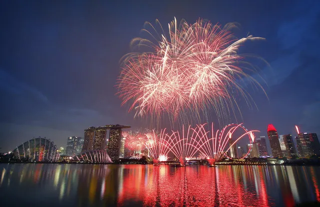 Fireworks explode above Singapore's financial skyline at dusk as part of celebrations for the nation's 50th year of independence, Sunday, August 9, 2015, in Singapore. Singapore declared independence on August 9, 1965. (Photo by Wong Maye-E/AP Photo)