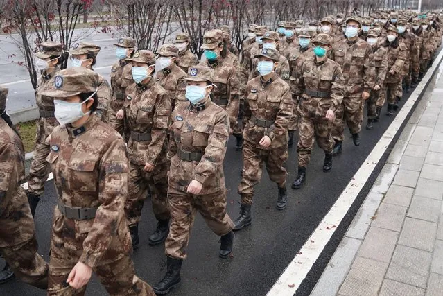 Members of a military medical team head for Wuhan Jinyintan Hospital in Wuhan, central China's Hubei Province, on January 26, 2020. Three teams of military staff totaling 450, who flew to Wuhan on Friday night, immediately started work in three designated hospitals in Wuhan. (Photo by Cheng Min/Xinhua News Agency/Eyevine)