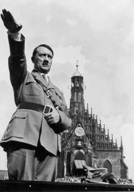 German dictator Adolf Hitler (1889-1945) giving the Nazi salute from his car whilst at the Nazi Party Congress, 1934. (Photo by Getty Images/Hulton Archive)