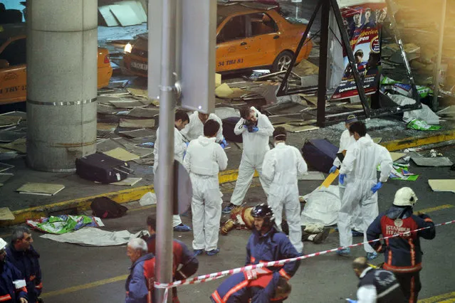 Turkish forensic police officers work at the scene of a blast outside Istanbul's Ataturk airport, late Tuesday, June 28, 2016. (Photo by Emrah Gurel/AP Photo)